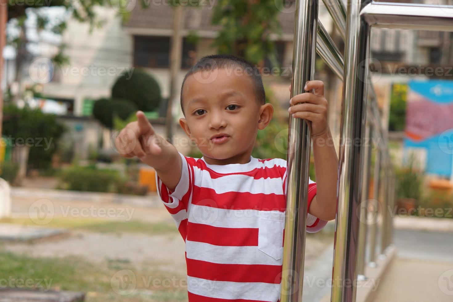 boy pointing his finger forward photo