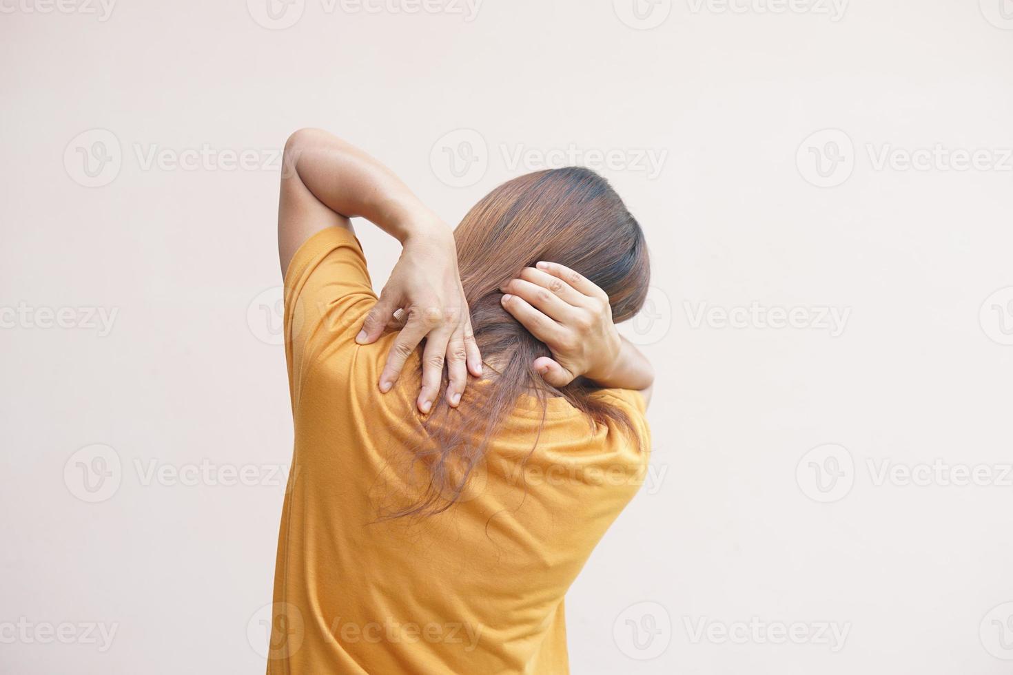 Asian woman suffering from neck pain from work photo