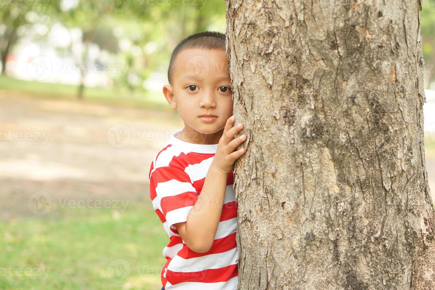 concept of saving the world boy hugging a tree photo