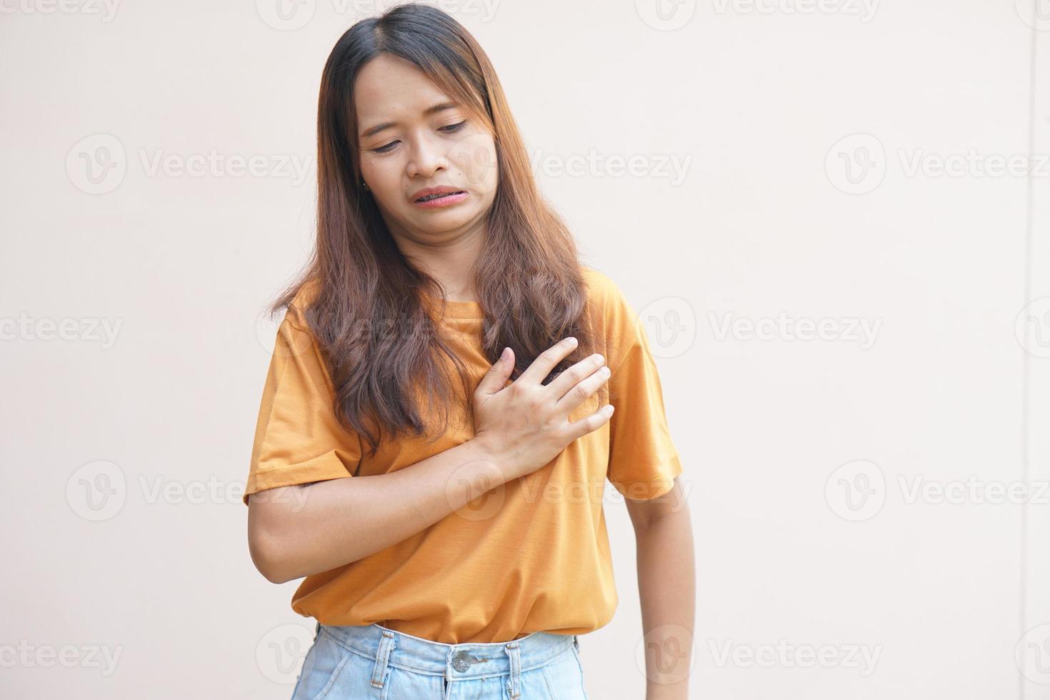 Asian woman having chest tightness photo