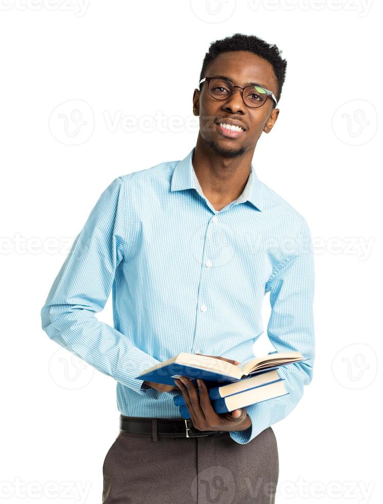 African american college student with books and bottle of water in his hands standing on white photo