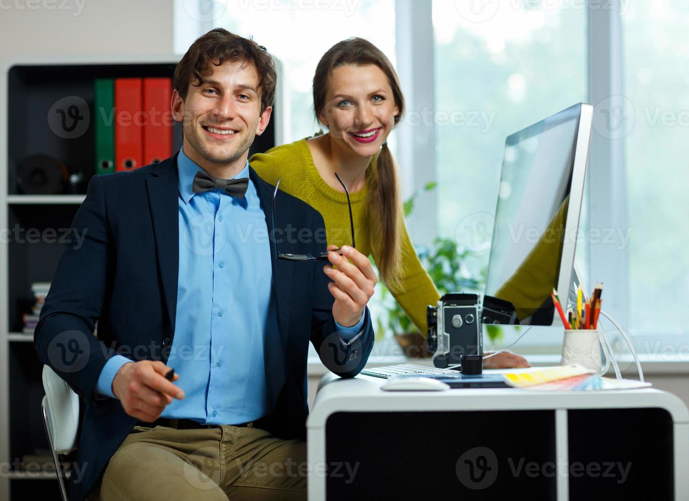 Beautiful young woman and man working from home photo