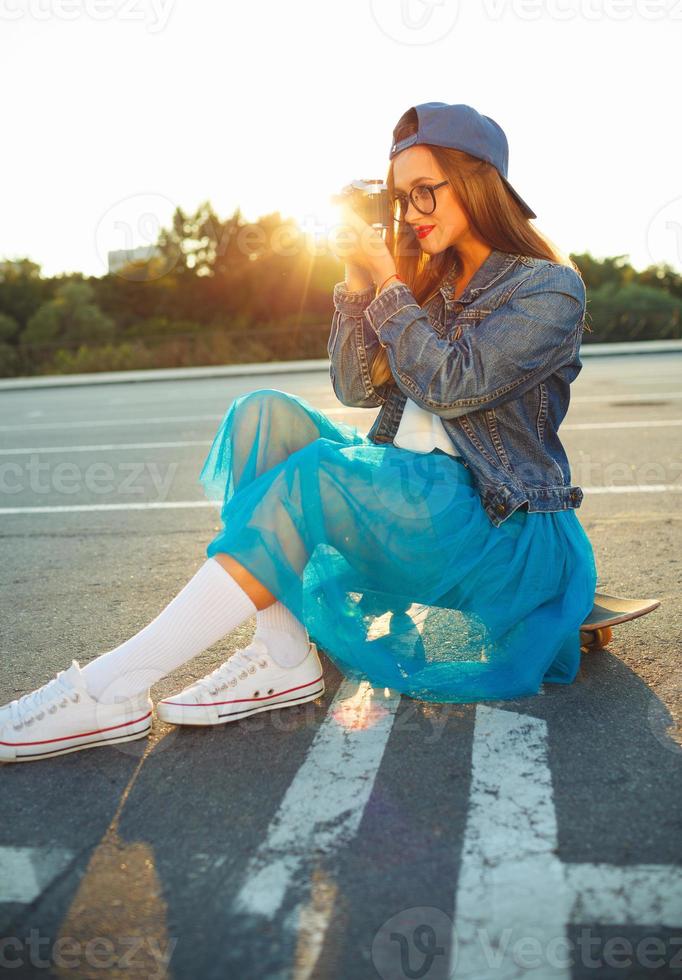 Summer lifestyle portrait of hipster girl with old camera photo