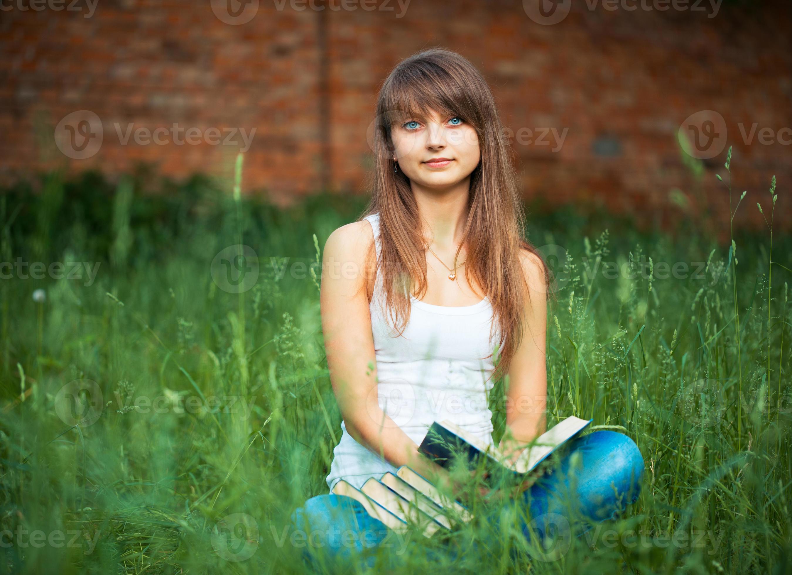 beautiful-girl-with-book-in-the-park-21194358-stock-photo-at-vecteezy