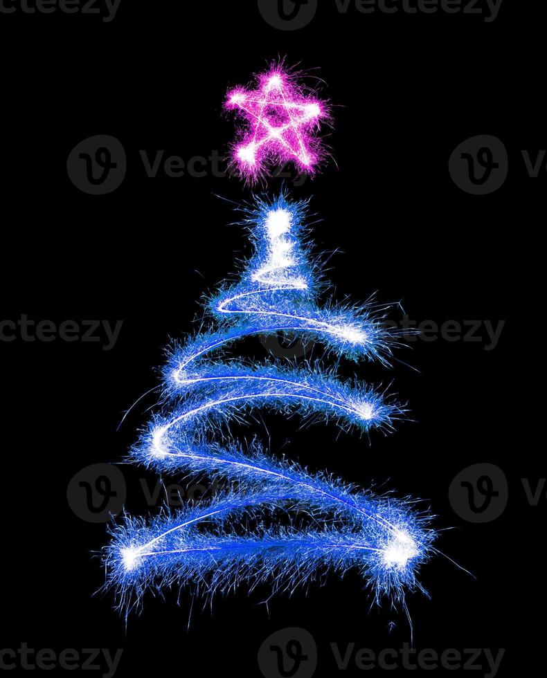 Christmas tree made by sparkler on a black photo