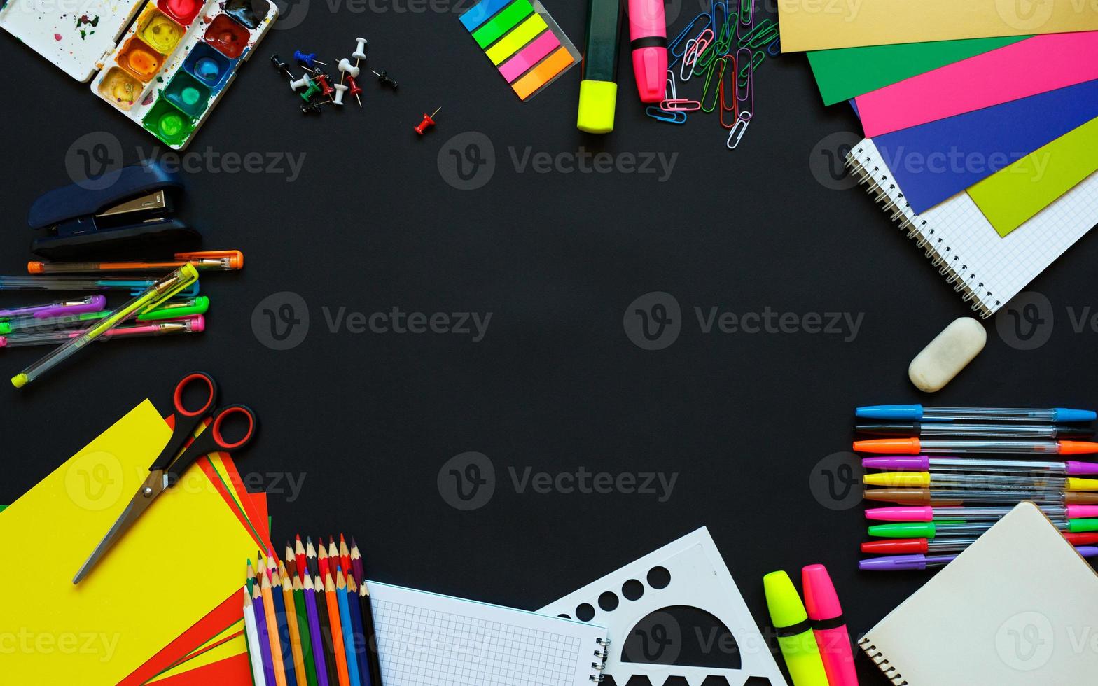 School supplies on blackboard background ready for your design photo