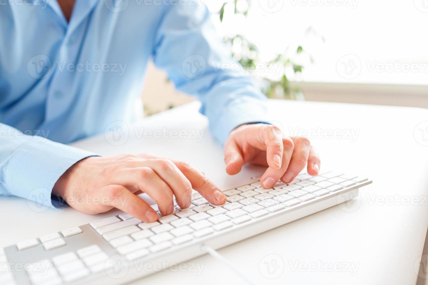 Men office worker typing on the keyboard photo