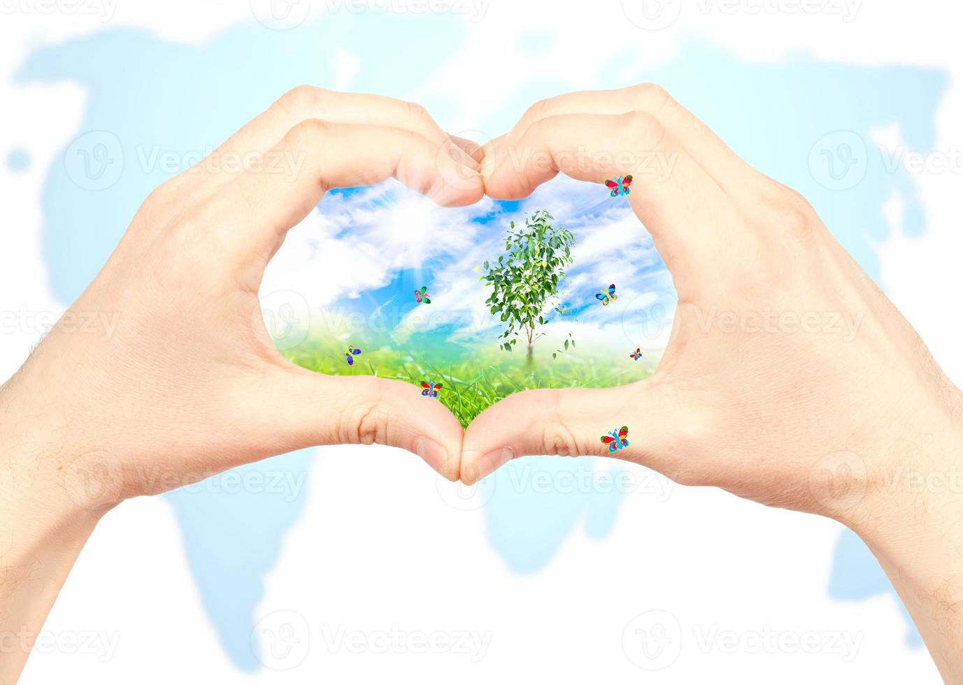 Human hand and nature on world map background. photo