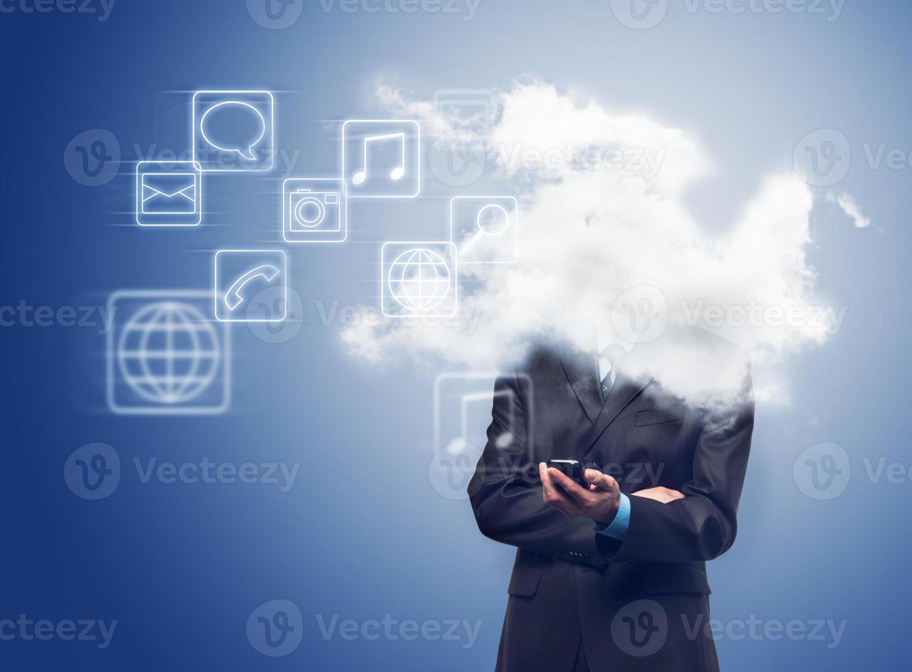 Businessman with phone and the cloud with applications icons photo