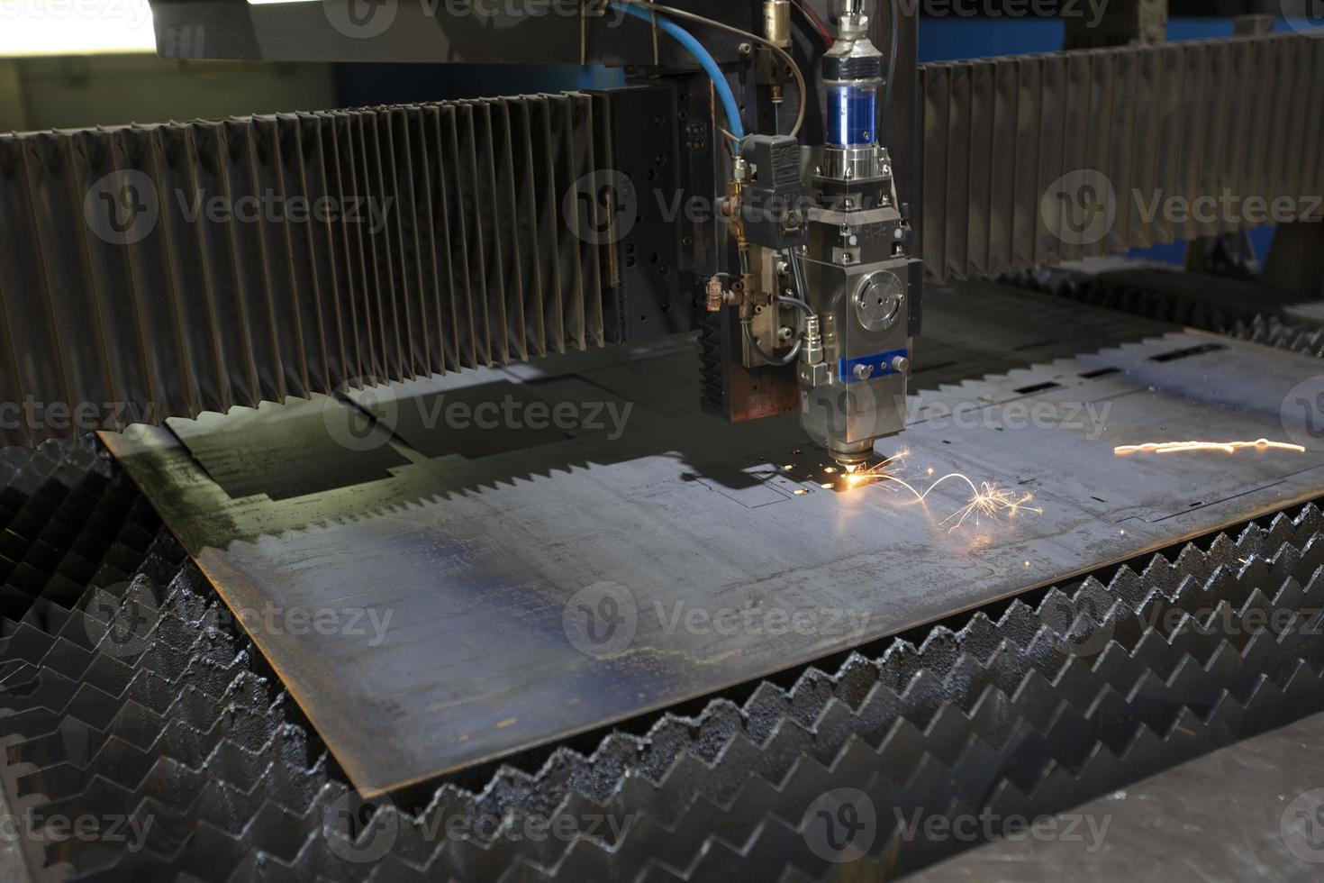 Cutting of metal. Sparks fly from laser.Laser cutting machine working with sheet metal with sparks at factory, plant. photo