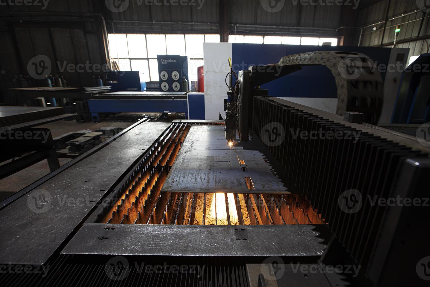 Cutting of metal. Sparks fly from laser.Laser cutting machine working with sheet metal with sparks at factory, plant. photo