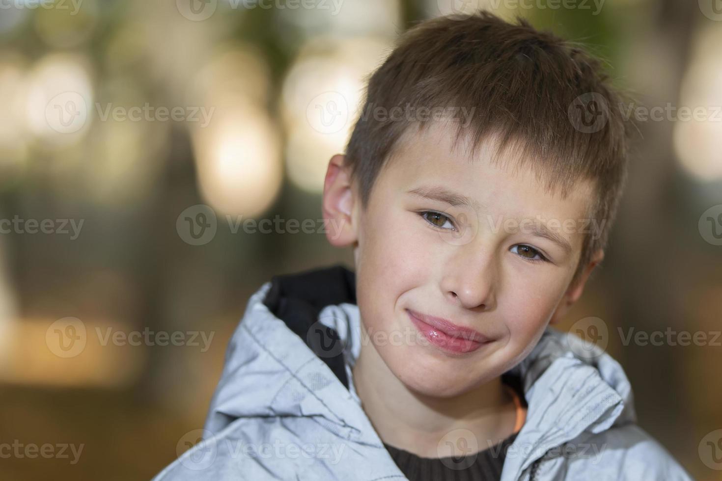 Portrait of a ten-year-old boy against the backdrop of an autumn park. photo