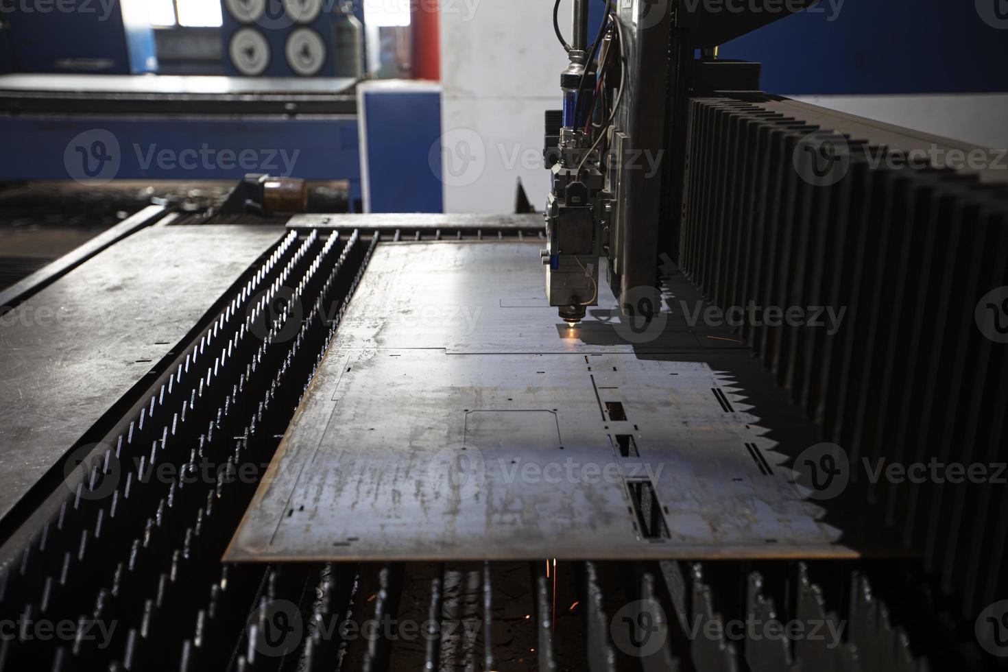 Cutting of metal. Sparks fly from laser.Laser cutting machine working with sheet metal with sparks at factory, plant. photo