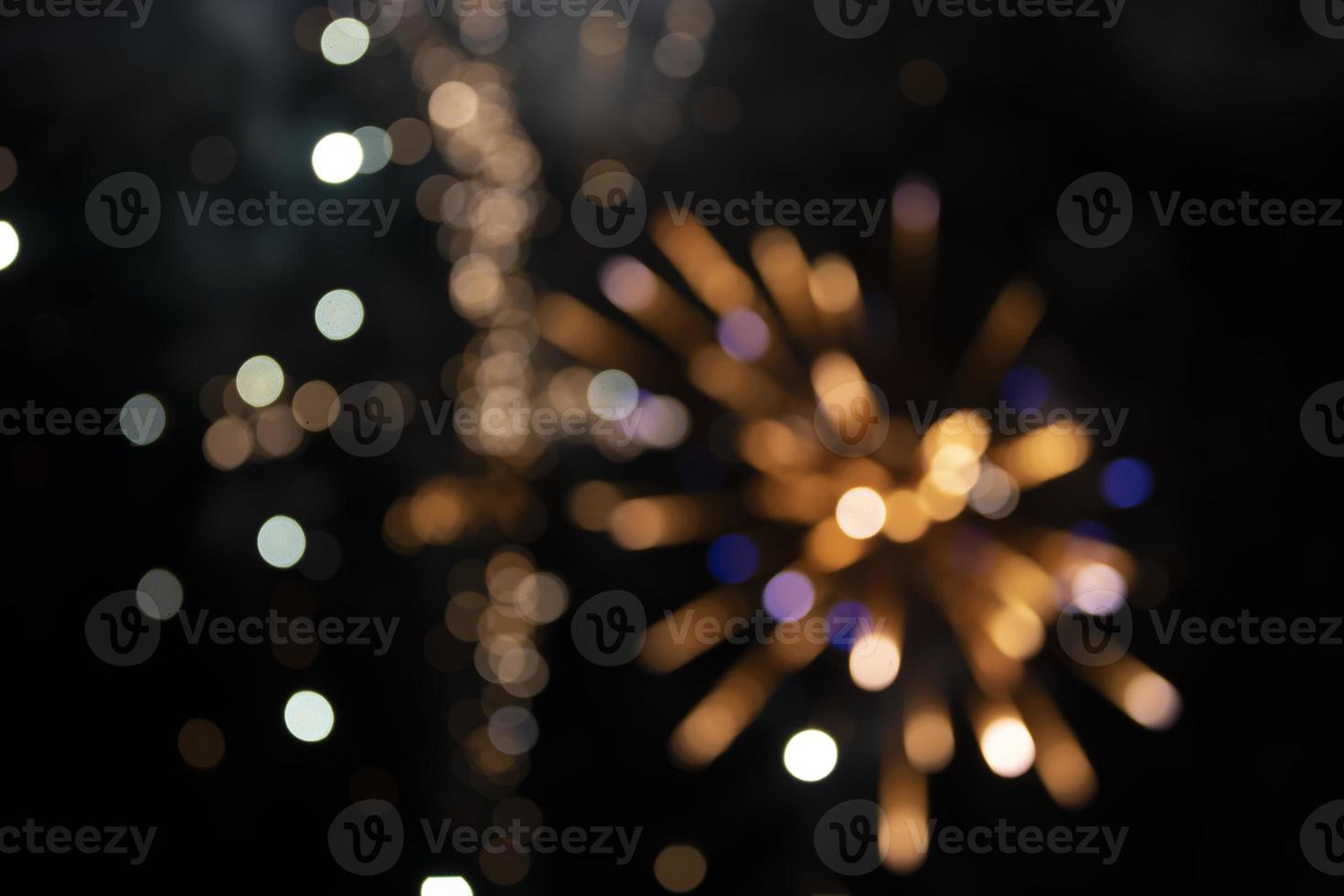 On a black background bokeh from explosions of colorful fireworks. photo