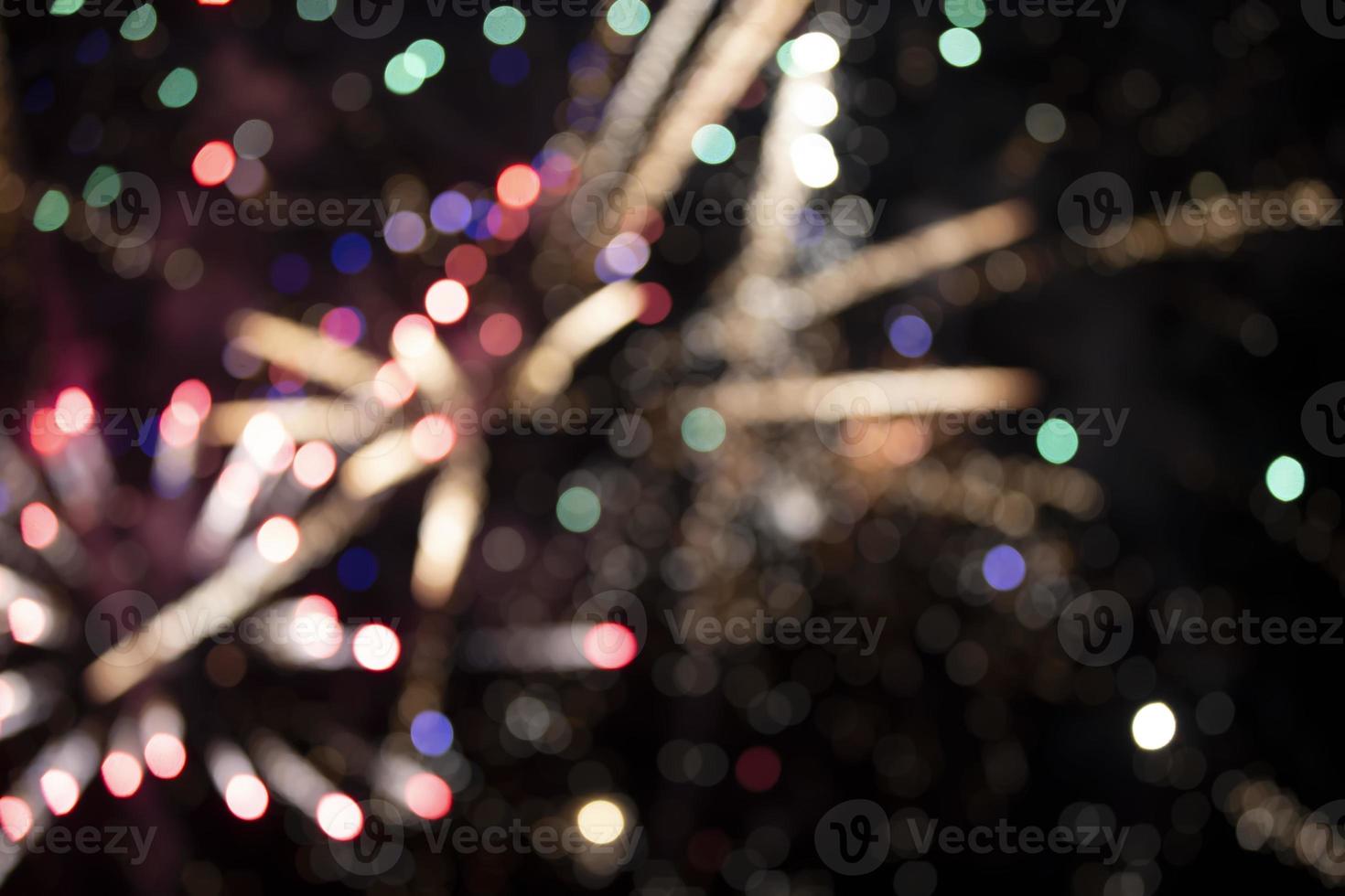 On a black background bokeh from explosions of colorful fireworks. photo