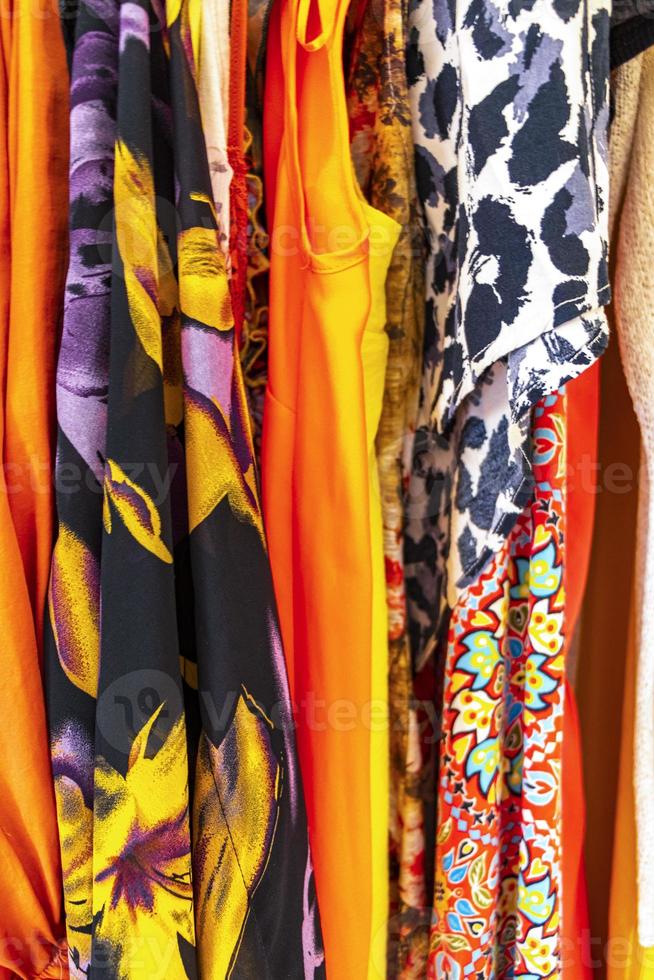 Colorful women clothes and dresses on hangers in closet Mexico. photo