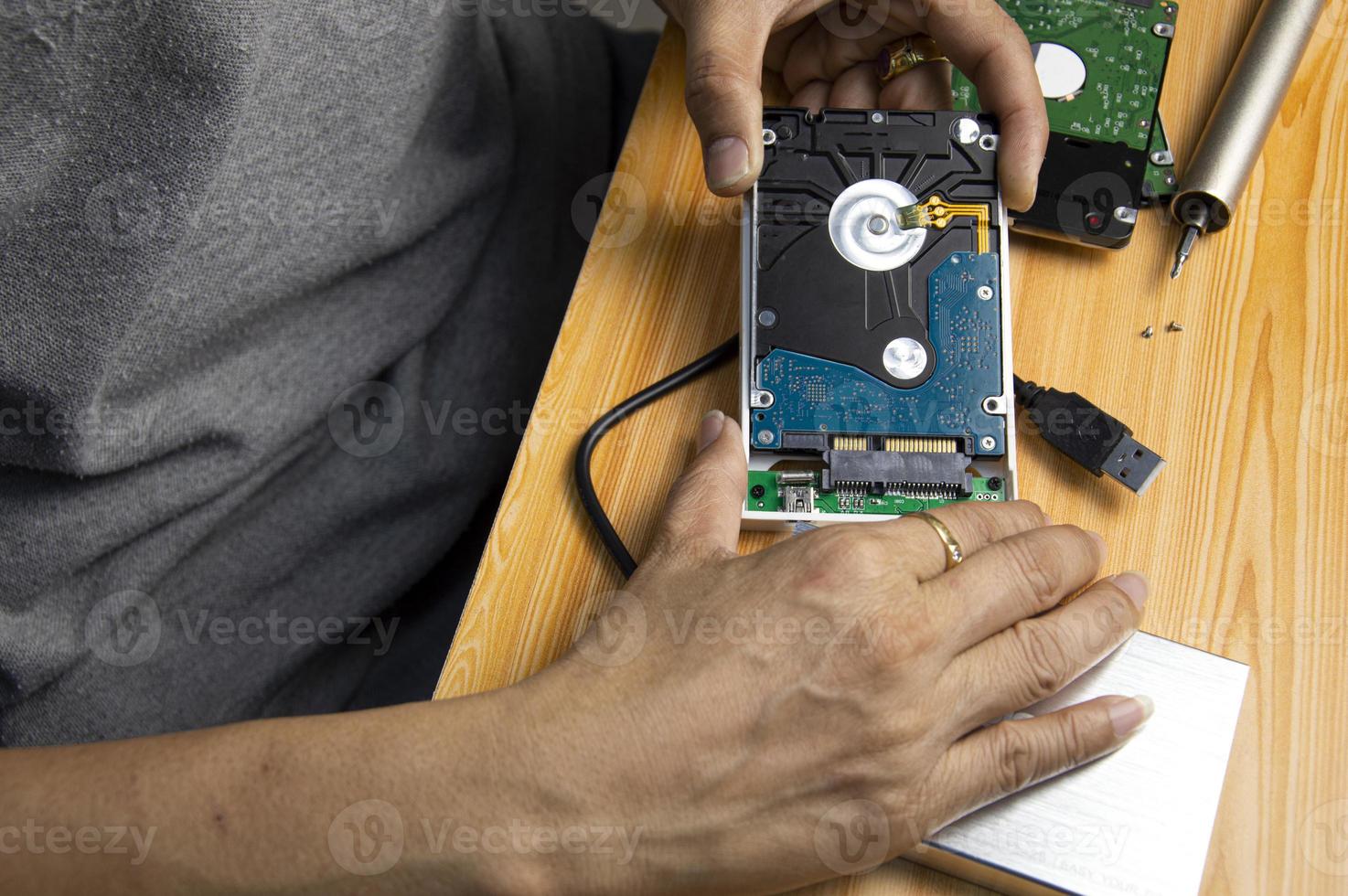 top view, man assembling an external hard drive photo