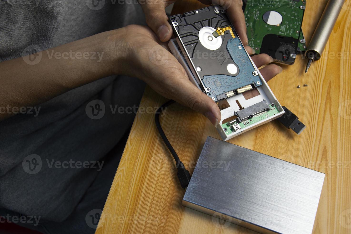 top view, man assembling an external hard drive photo