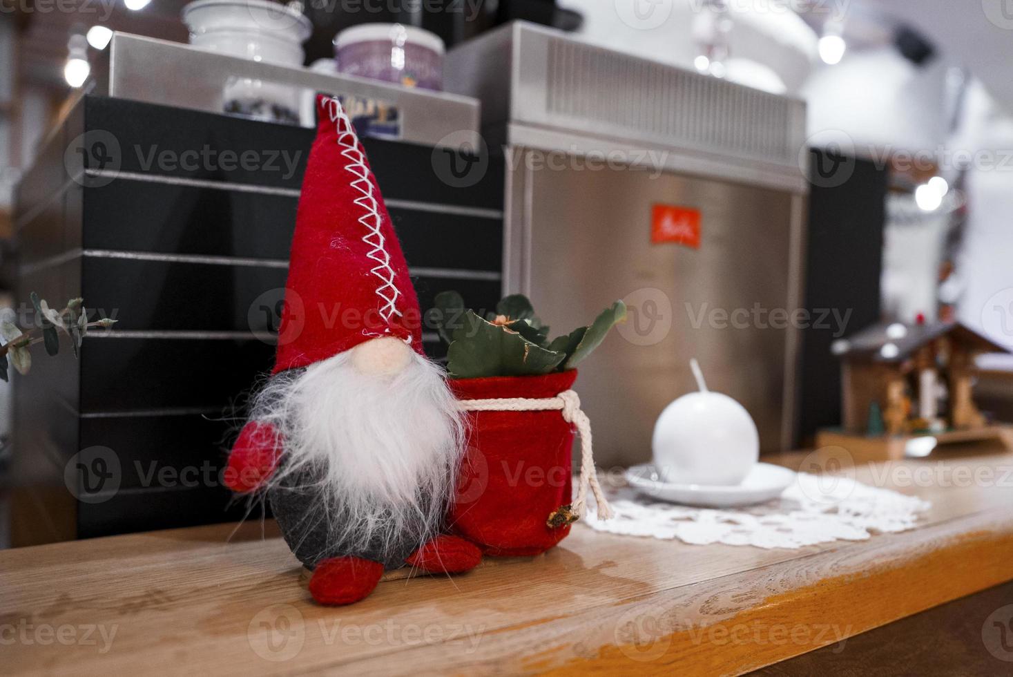 Closeup of santa claus and plant decors displayed on table in hotel photo