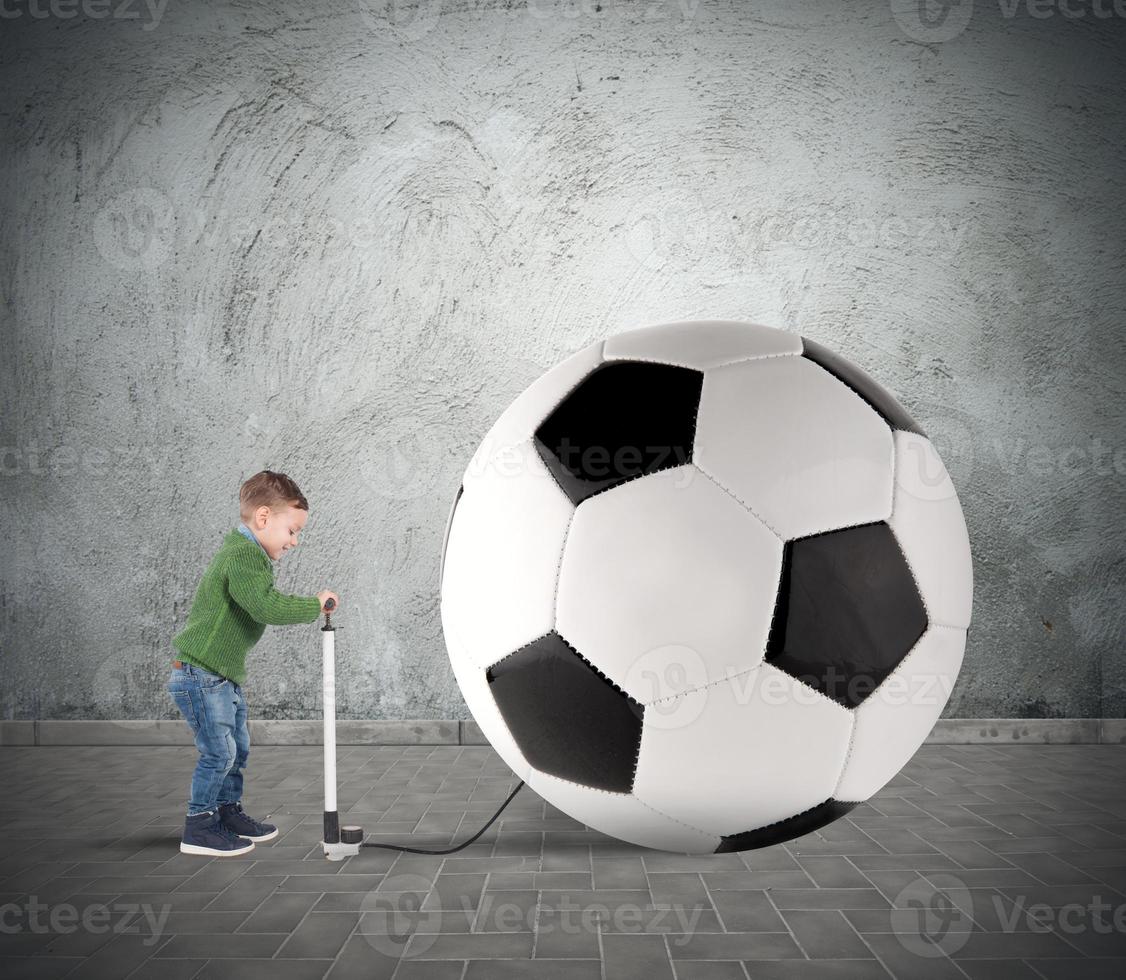 Young kid with Big soccer ball photo