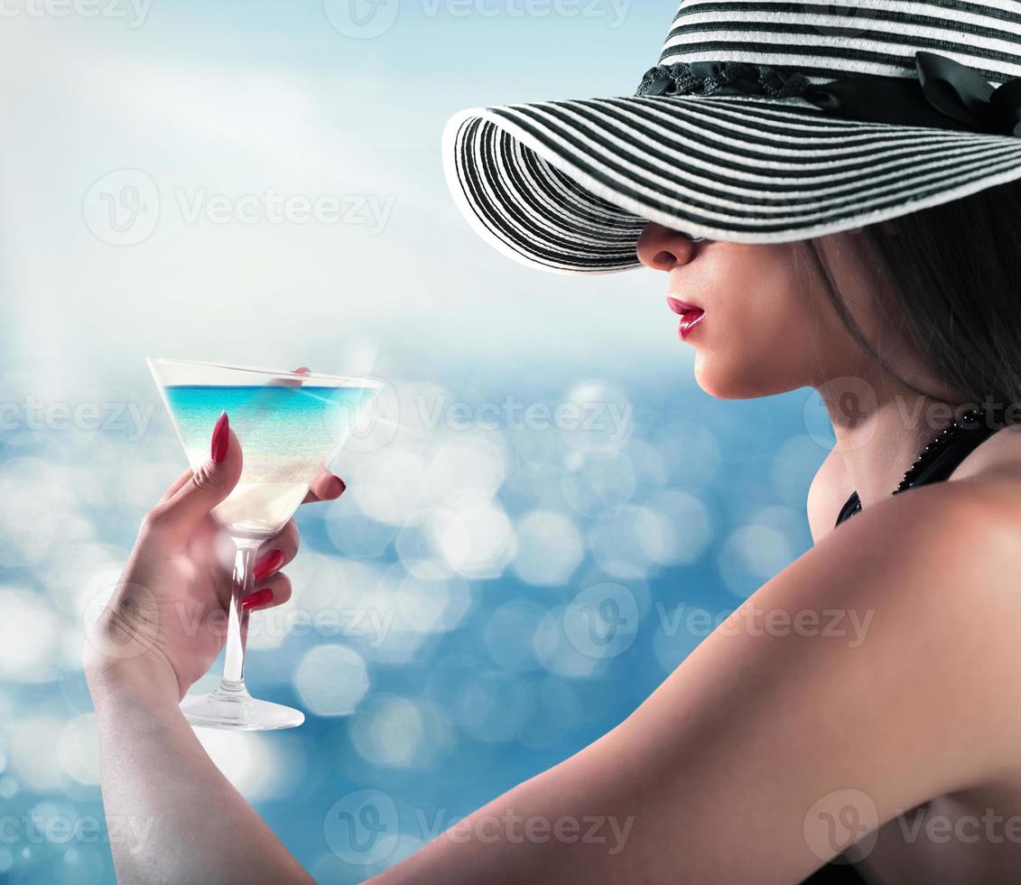 Woman enjoying a cocktail photo