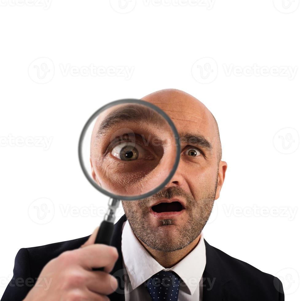 Stunning discovery. Businessman with magnifying glass photo