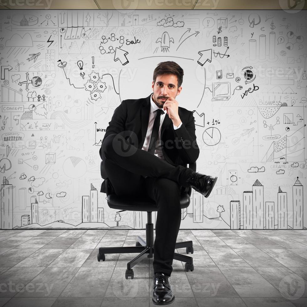 Confident businessman sitting on a chair photo