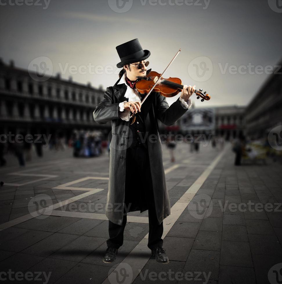 Street musician playing violin photo