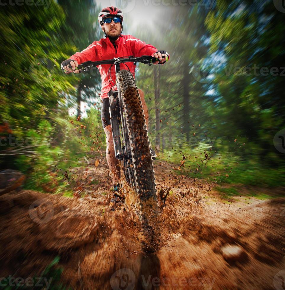 Extreme cyclist on a mountain bike photo