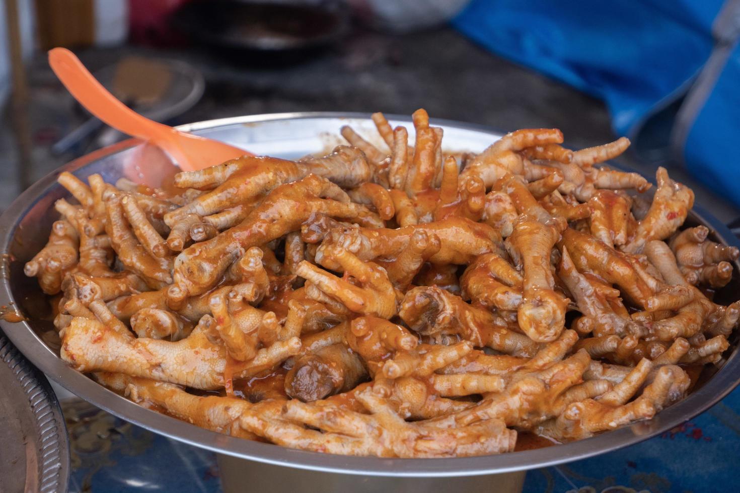 stir-fried chicken legs with chili sauce, in Indonesian it is called stir-fried chicken feet. served on a pot for sale at culinary festivals photo