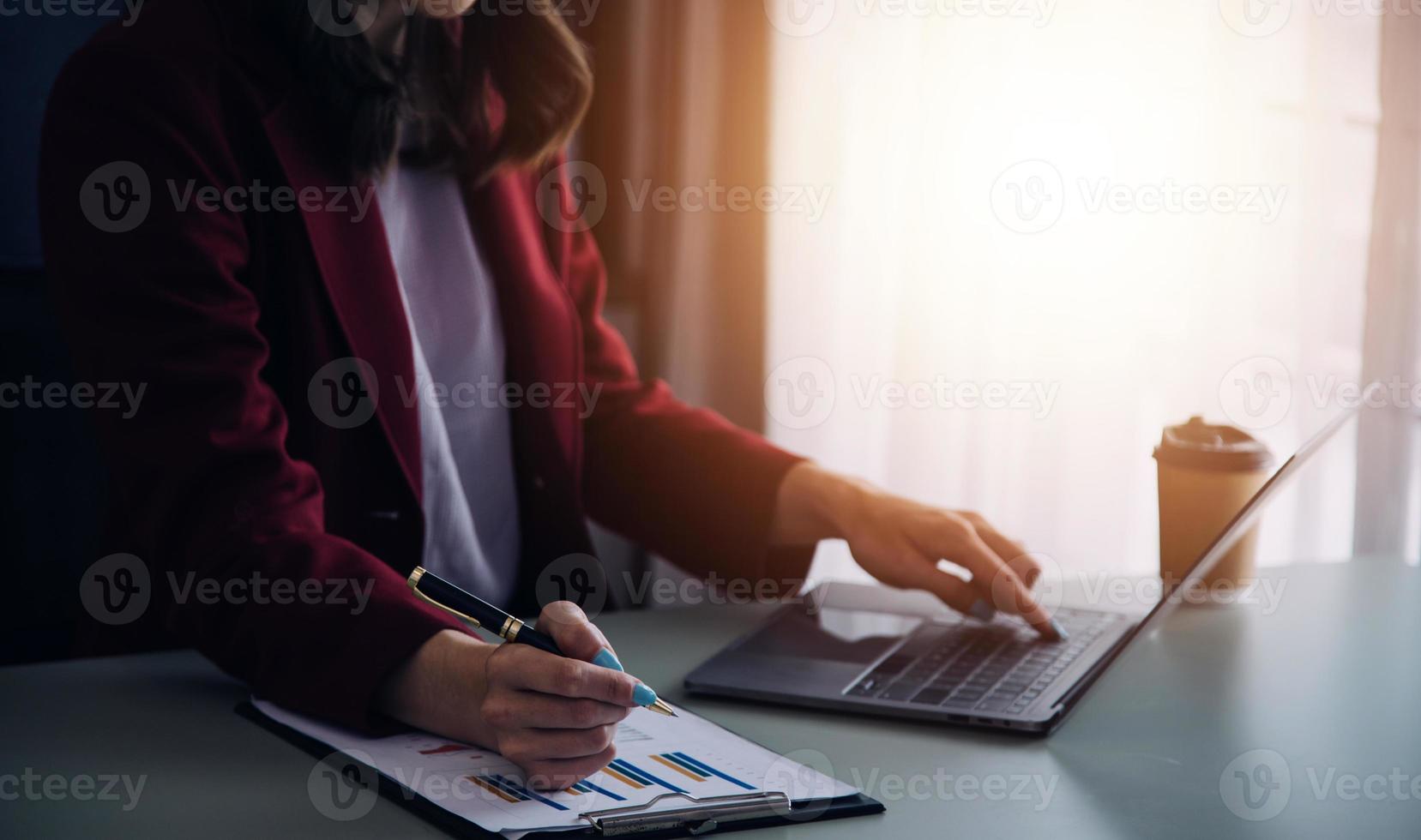 Young adult happy smiling Hispanic Asian student wearing headphones talking on online chat meeting using laptop in university campus or at virtual office. College female student learning remotely. photo