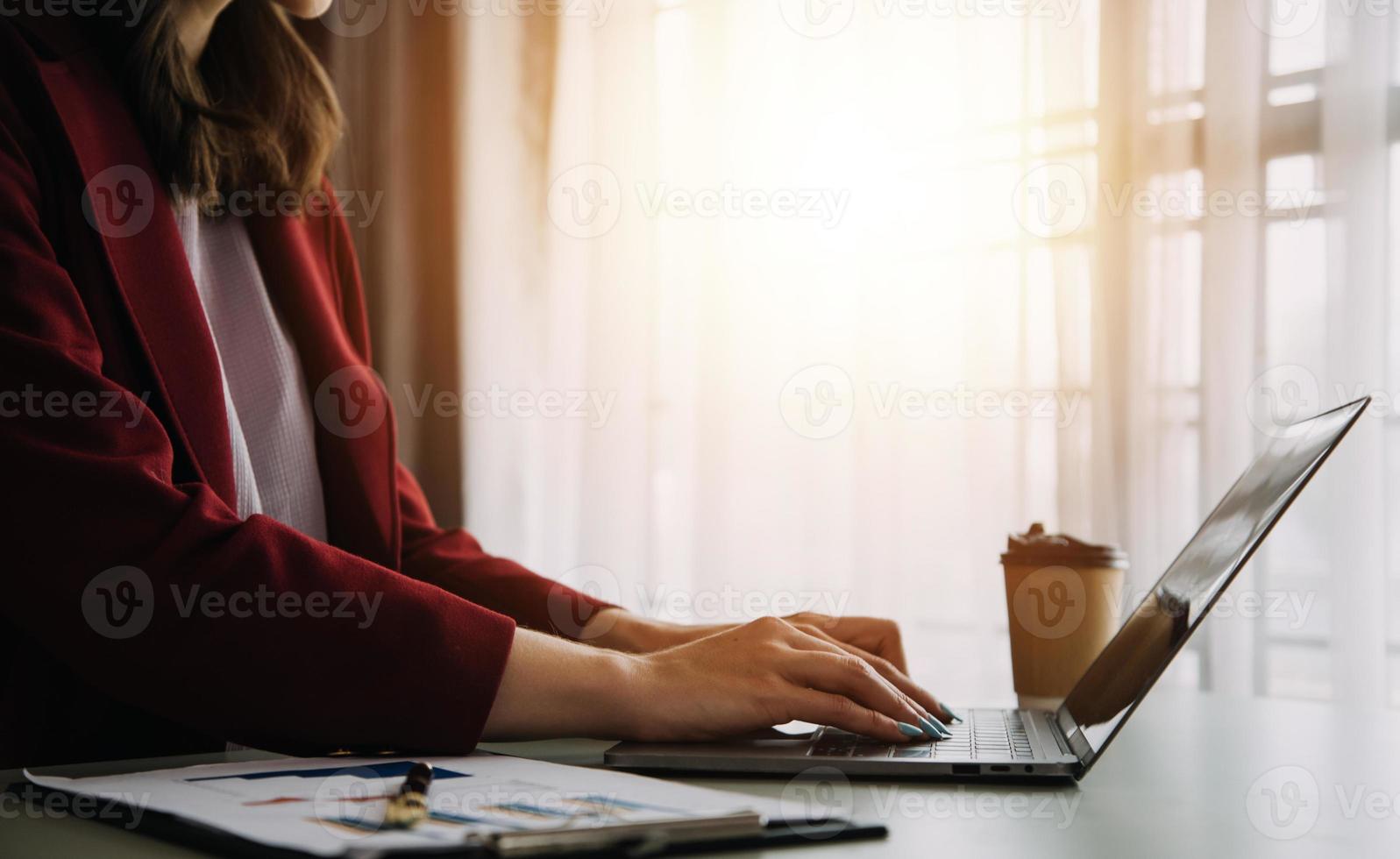 Young adult happy smiling Hispanic Asian student wearing headphones talking on online chat meeting using laptop in university campus or at virtual office. College female student learning remotely. photo