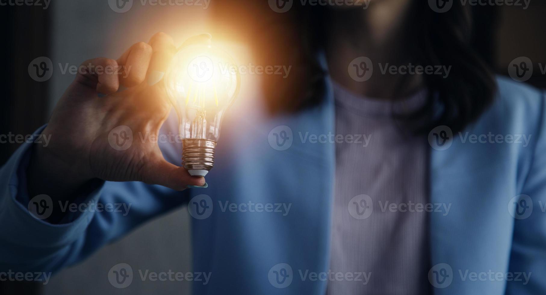 woman Hand holding Light bulb Global Internet connection. Business global internet connection application technology and digital marketing, Financial and banking, Digital link tech, big data. photo