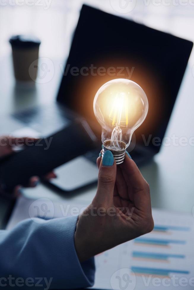 woman Hand holding Light bulb Global Internet connection. Business global internet connection application technology and digital marketing, Financial and banking, Digital link tech, big data. photo