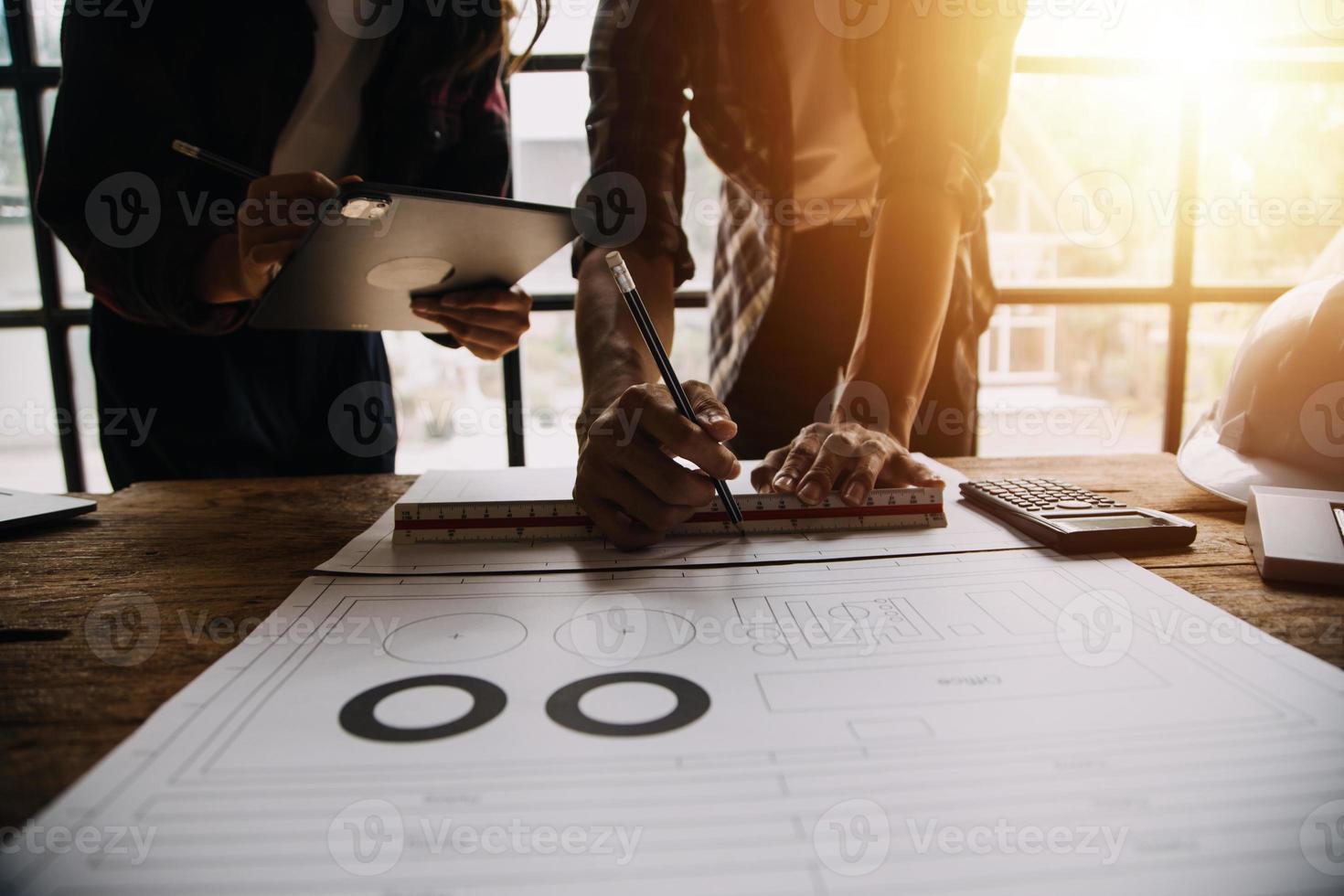 Two business man construction site engineer. Engineering objects on workplace with partners interacting on background photo