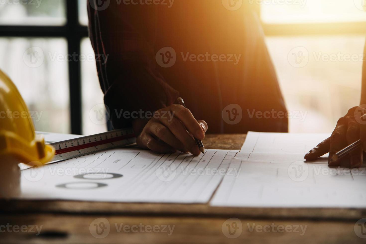 Two business man construction site engineer. Engineering objects on workplace with partners interacting on background photo