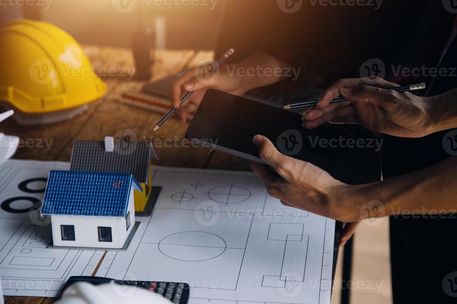 Two business man construction site engineer. Engineering objects on workplace with partners interacting on background photo