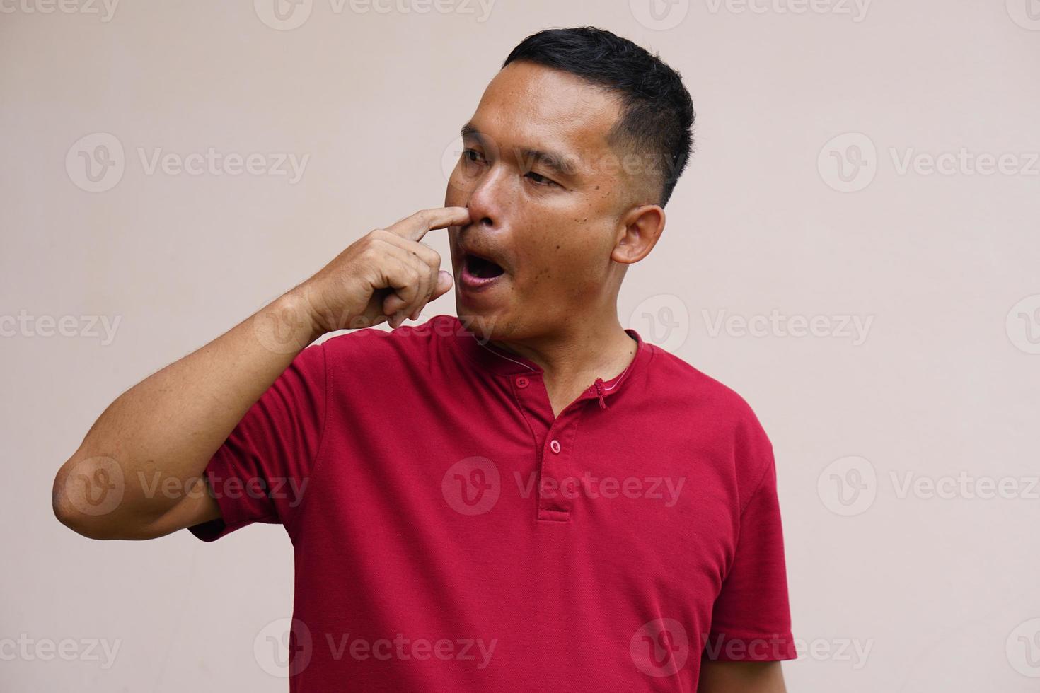 men use their hands to pick up their noses. photo