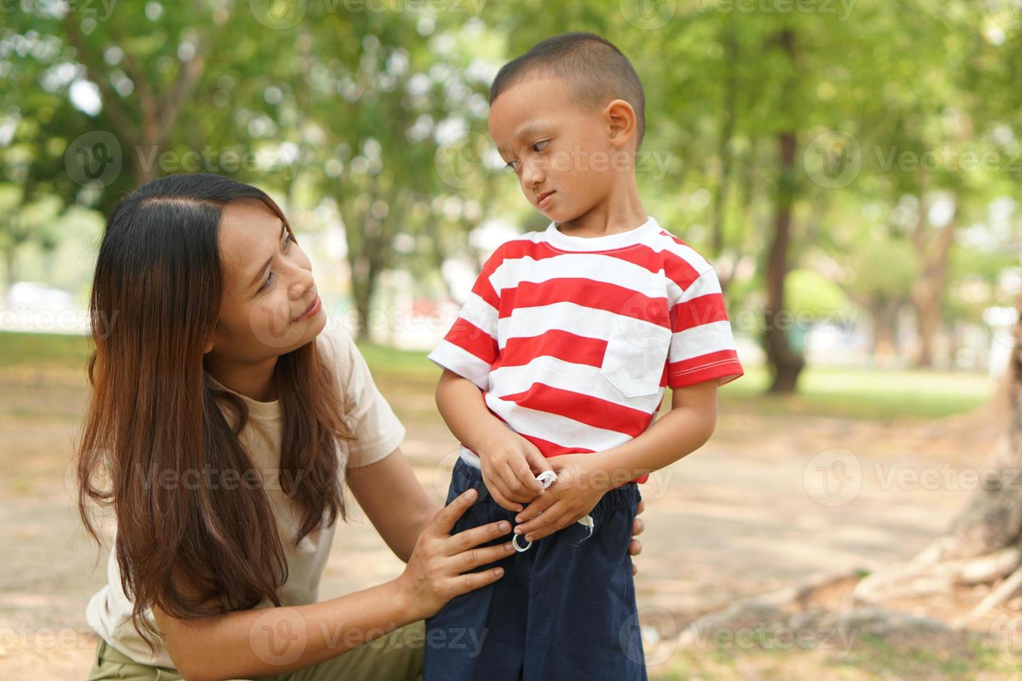 Mother and baby playing in the park happily. photo