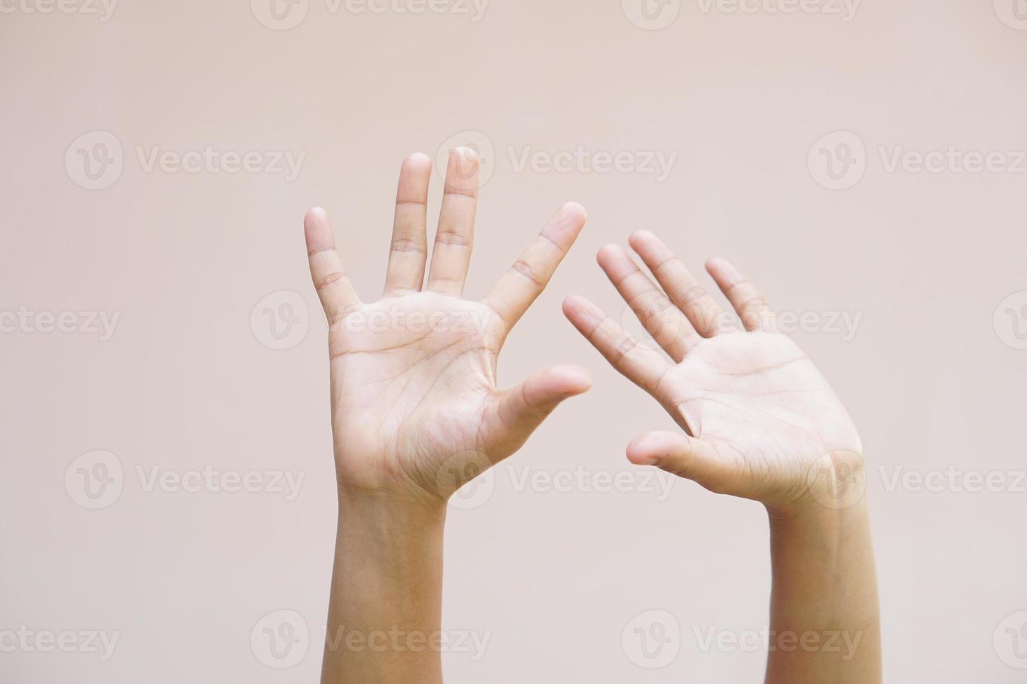 Asian woman raising her hands up photo