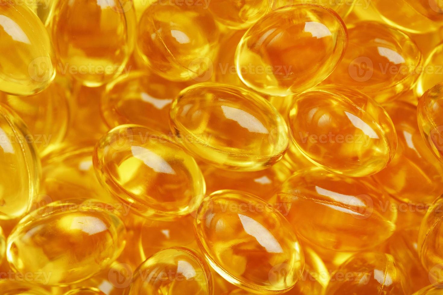 Golden capsules of Vitamin Omega 3 Fish Oil close-up photo