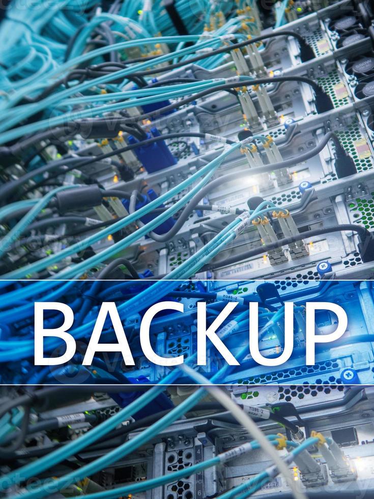 Backup button on modern server room background. Data loss prevention. System recovery. photo