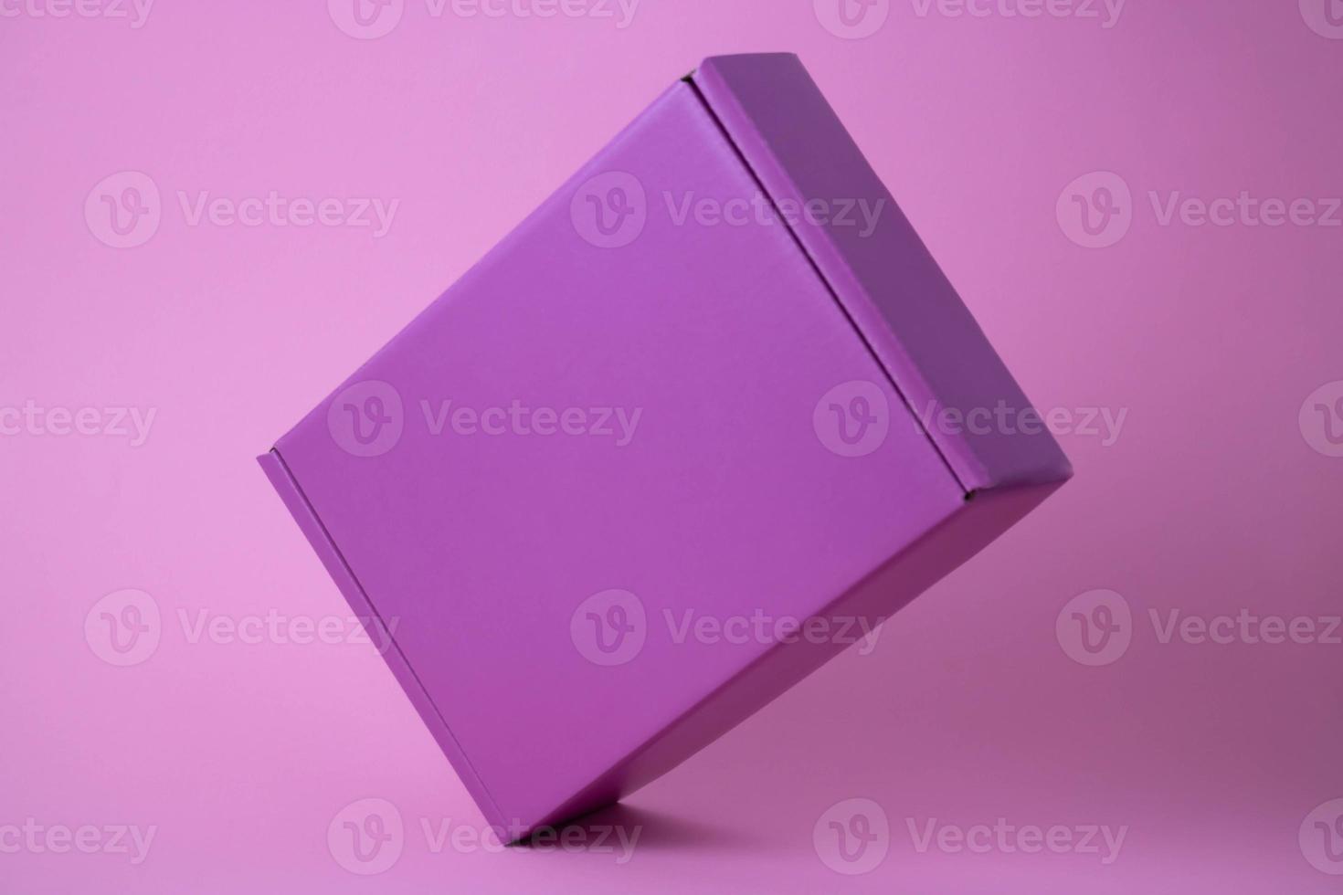 Lilac gift closed box on pink background photo