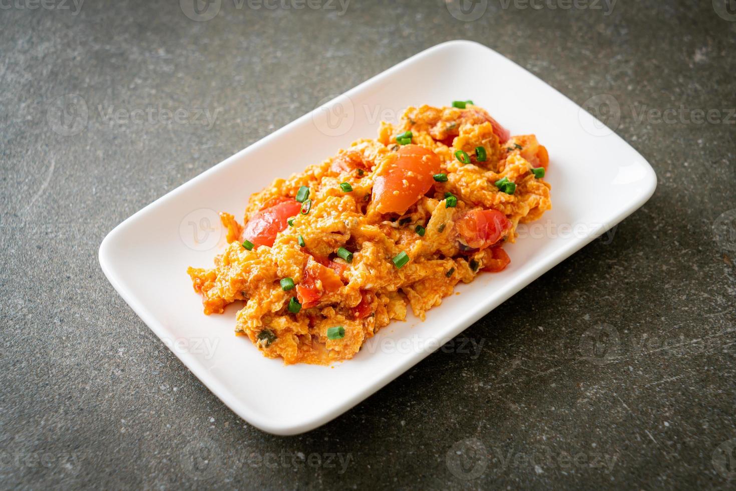 Stir-fried tomatoes with egg or Scrambled eggs with tomatoes photo
