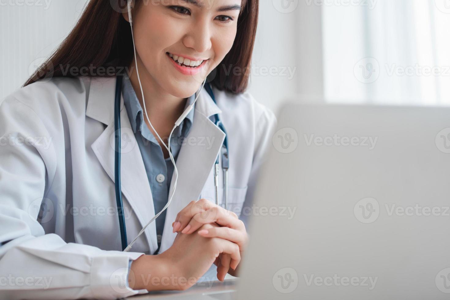 Asian therapist woman doctor is online visiting with a patient on the internet application. Her Listening and Give advice and explains how to treat the initial disease, Concept of Medical technology. photo