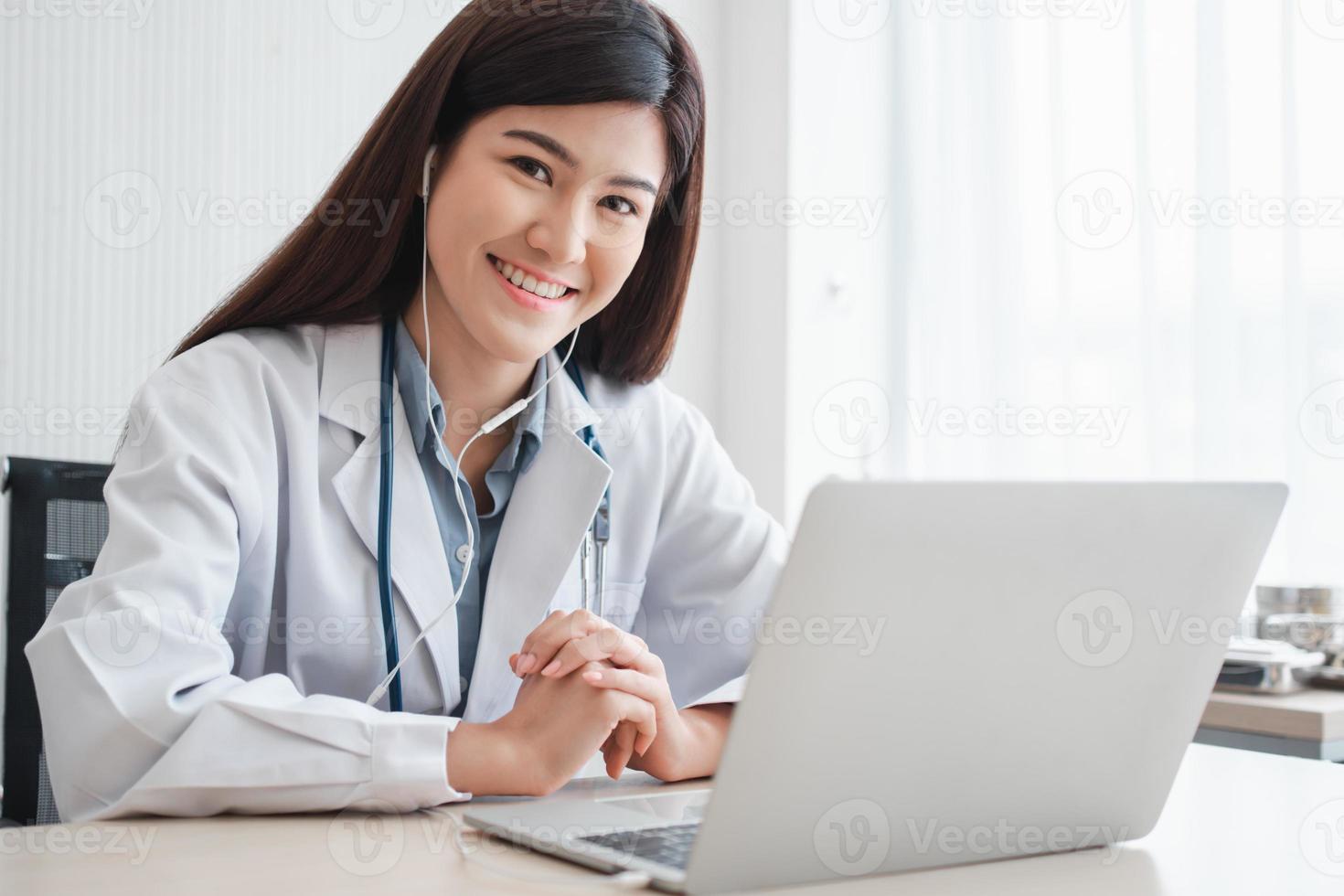 Asian therapist woman doctor is online visiting with a patient on the internet application. Her Listening and Give advice and explains how to treat the initial disease, Concept of Medical technology. photo