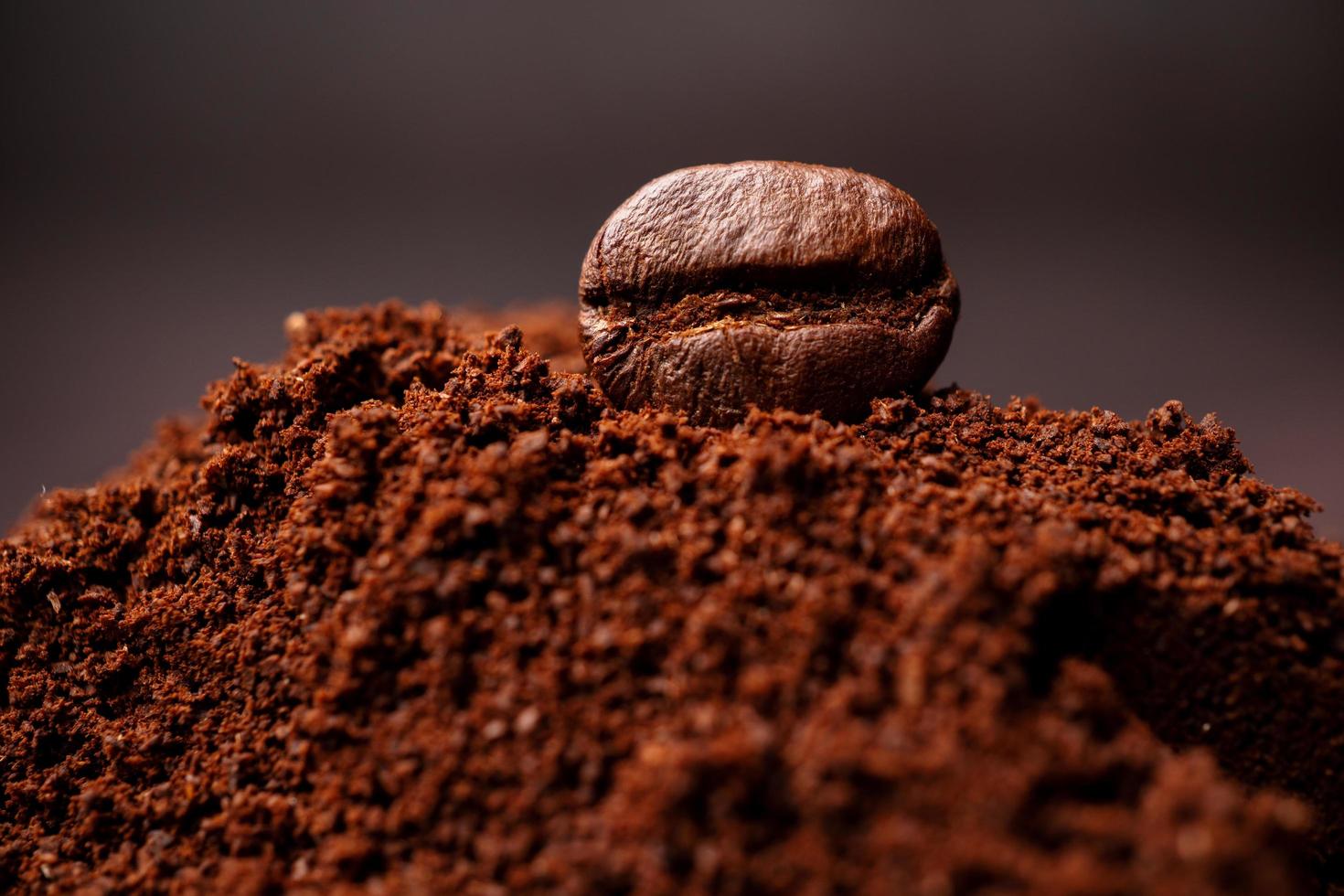 Closeup of coffee beans at the mixed heap of roasted coffee with copy space for text. Concept of Coffee freshness photo