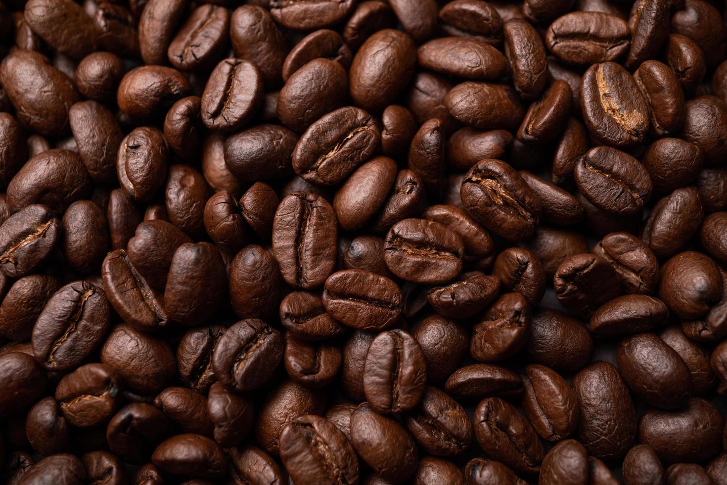 Close up of group black coffee beans. Strong black espresso, Grounds of coffee background, texture photo