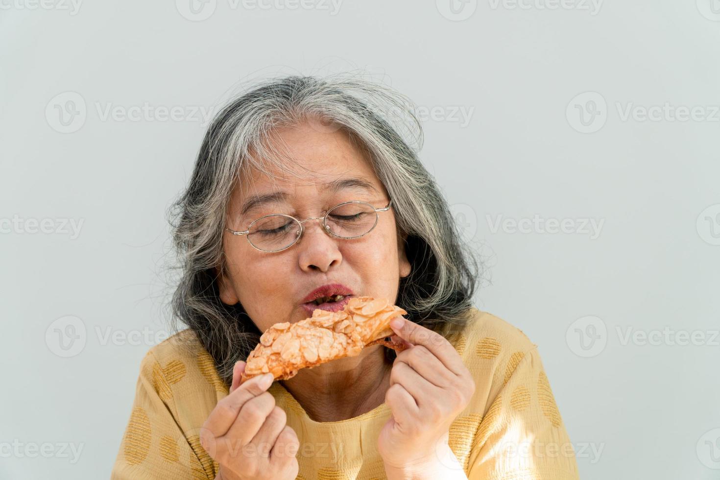 Happy Asian senior women enjoying eating pie photo