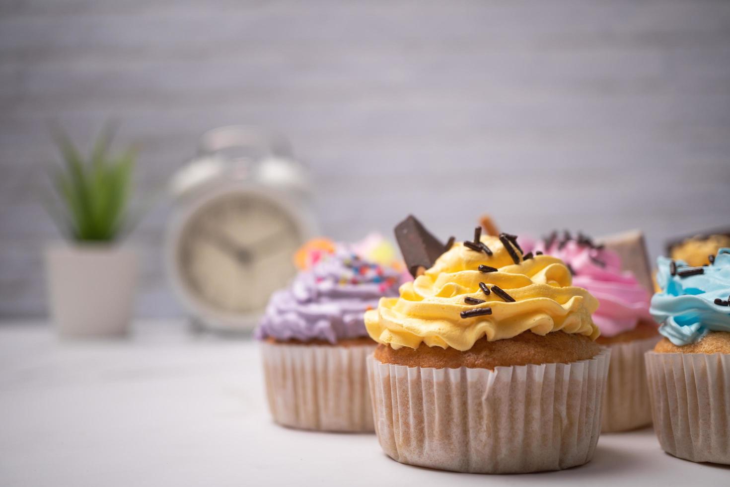 deliciosos cupcakes caseros con crema de colores y cobertura con dulces y galletas de chocolate. postre casero de vacaciones de otoño foto